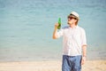 Man wearing hat and sunglasses enjoing beer in a Royalty Free Stock Photo