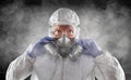 Man Wearing Hazmat Suit, Goggles and Gas Mask In Smokey Dark Room Royalty Free Stock Photo