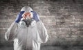 Man Wearing Hazmat Suit, Protective Gas Mask and Goggles Against Brick Wall Royalty Free Stock Photo