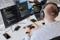 Man Wearing Headphones Working on Computer Programming Royalty Free Stock Photo