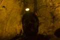 Man wearing helmet and spotlight in a deep cavern in Costa Rica Royalty Free Stock Photo