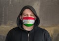 Man Wearing a hood and a Tajikistan flag Mask to Protect him virus