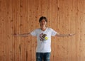 Man wearing Illinois flag shirt and standing with arms wide open on the wooden wall background, seal of Illinois on a white