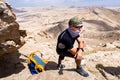 Man wearing keffiyeh standing desert mountain. Royalty Free Stock Photo