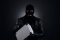 Man wearing knitted balaclava with briefcase on black background Royalty Free Stock Photo