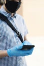 Man wearing latex gloves using his smartphone Royalty Free Stock Photo