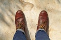 man wearing leather boots standing on cement floor. close up safety shoes Royalty Free Stock Photo