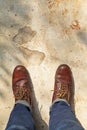 man wearing leather boots standing on cement floor Royalty Free Stock Photo