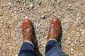 Man wearing leather boots standing on country road. close up safety shoes Royalty Free Stock Photo