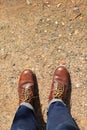 Man wearing leather boots standing on country road Royalty Free Stock Photo