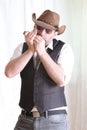 Man wearing leather cowboy hat playing harmonica Royalty Free Stock Photo