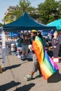 Man wearing LGBT flag before Hillary stand during Rockland Pride