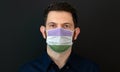 Man wearing a LGBT genderqueer flag colors protective face mask