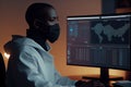 a man wearing a mask looking at a computer screen. Generative AI Royalty Free Stock Photo
