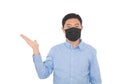 A man wearing a mask makes an explanatory gesture in front of a white background