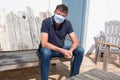 Man wearing medical mask outdoors in residential home garden in Coronavirus quarantine in house Royalty Free Stock Photo