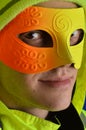 Man wearing neon mask and winter clothing