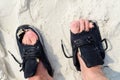 A Man wearing old worn out shoes on feet with holes Royalty Free Stock Photo