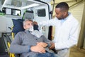 Man wearing oxygen mask on ambulance stretcher