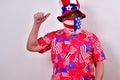 Man wearing patriotic shirt and face mask pointing