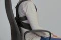 Man wearing a posture corrector while sitting