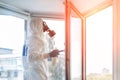 Man wearing protective biological suit and gas-mask due to mers coronavirus global pandemic warning and danger. Medic sphysician