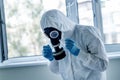 Man wearing protective biological suit and gas-mask due to mers coronavirus global pandemic warning and danger. Medic sphysician Royalty Free Stock Photo