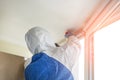 Man wearing protective biological suit and gas-mask due to mers coronavirus global pandemic warning and danger. Worker make Royalty Free Stock Photo