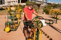 A man wearing a protective face mask at an outdoor public fitness park Royalty Free Stock Photo