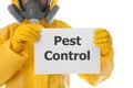 Man wearing protective suit holding sign PEST CONTROL on white background Royalty Free Stock Photo