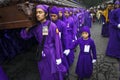 Man wearing purple robes, carrying a float anda during the Easter celebrations, in the Holy Week, in Antigua, Guatemala.