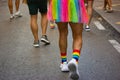 Man wearing rainbow LGBT skirt walking on city street at Gay parade. Pride month