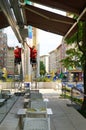 Man up on ladder cleaning glass window of restaurant in Bucharest, Romania on July 2, 2022