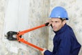 man wearing red safety gloves removing wall tails Royalty Free Stock Photo