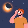 Man wearing safety glasses watch a partial solar eclipse