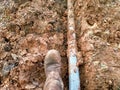 a man wearing safety shoes is taking a break from work digging the ground for a water pipe Royalty Free Stock Photo