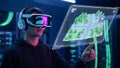 Man in VR Headset Interacting with Holographic 3D City Map Royalty Free Stock Photo