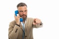 Man wearing smart casual clothes holding blue telephone pointing Royalty Free Stock Photo