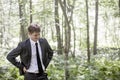 Man wearing suit in woods