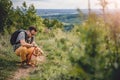 Man with a dog resting at the hiking trail