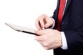 A man wearing a tie is working on a tablet computer on an isolated white background. Royalty Free Stock Photo