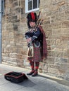 Man wearing traditional Scottish attire, playing a bagpipe on the street Royalty Free Stock Photo