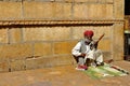 A man wearing turban is siting on ground and playing vilolin at Jaiselmer Rajasthan India Royalty Free Stock Photo