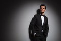 Man wearing tuxedo standing with hands in pockets, looks up Royalty Free Stock Photo