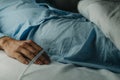 man wearing a urinary catheterization in bed
