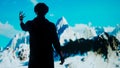 Man wearing virtual reality glasses stands in front of big digital screen playing moving mountains, cyber visual Royalty Free Stock Photo