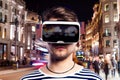 Man wearing virtual reality goggles against night city Royalty Free Stock Photo