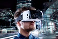 Man wearing virtual reality goggles against night city Royalty Free Stock Photo