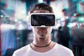 Man wearing virtual reality goggles against night city Royalty Free Stock Photo