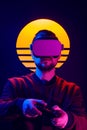Man wearing virtual reality goggles playing video game with gamepad joystick controller